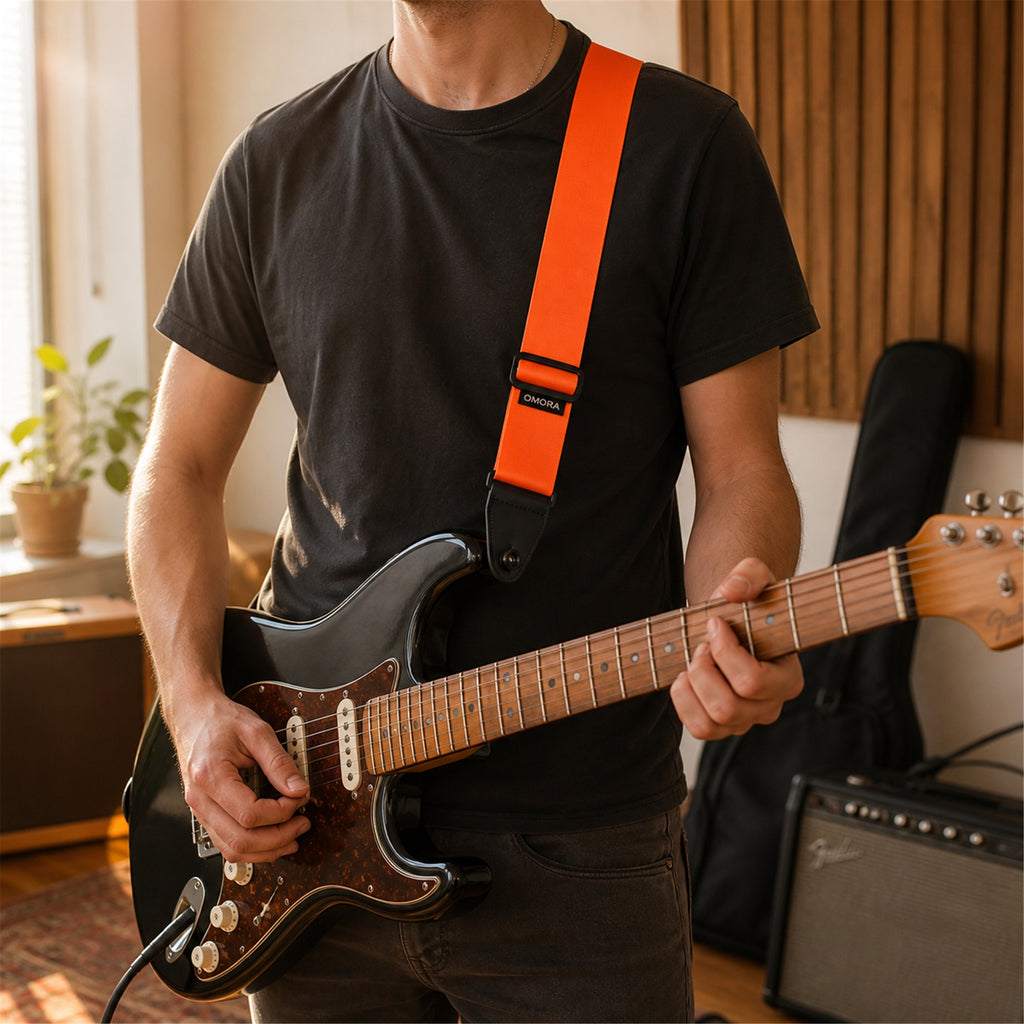 OMORA Lockstep Strap — Signal Orange in a warm music lifestyle setting.