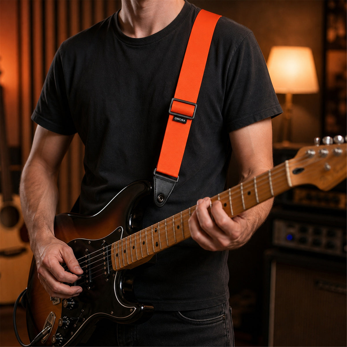 OMORA Lockstep Strap — Signal Orange in a creative music setup.