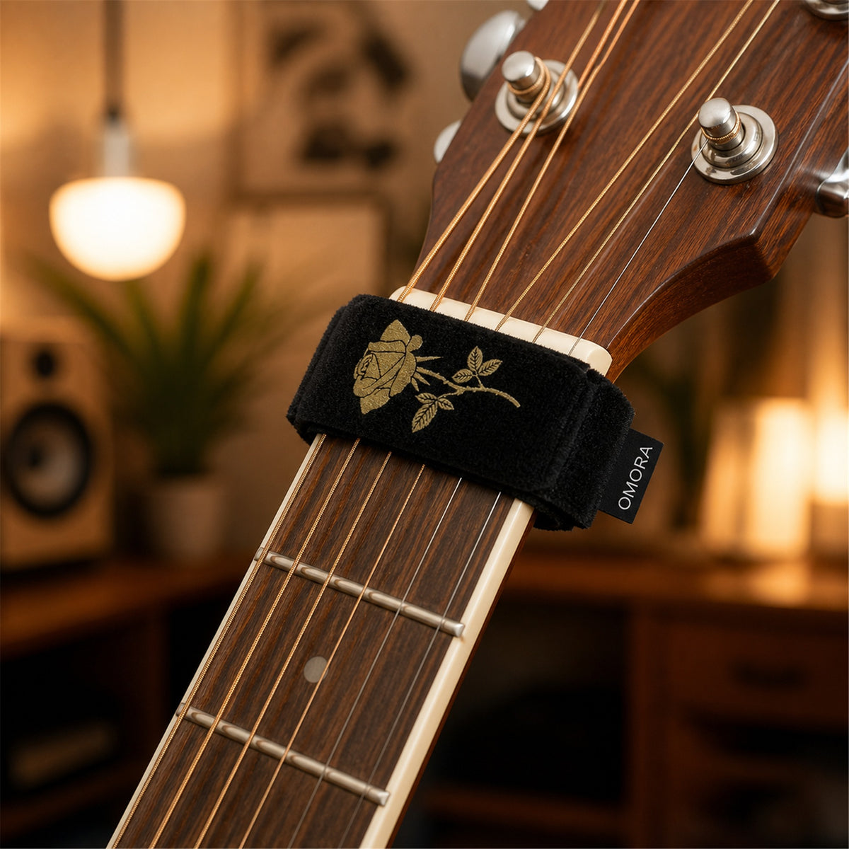 OMORA Rose String Dampener in a warm music lifestyle setting.